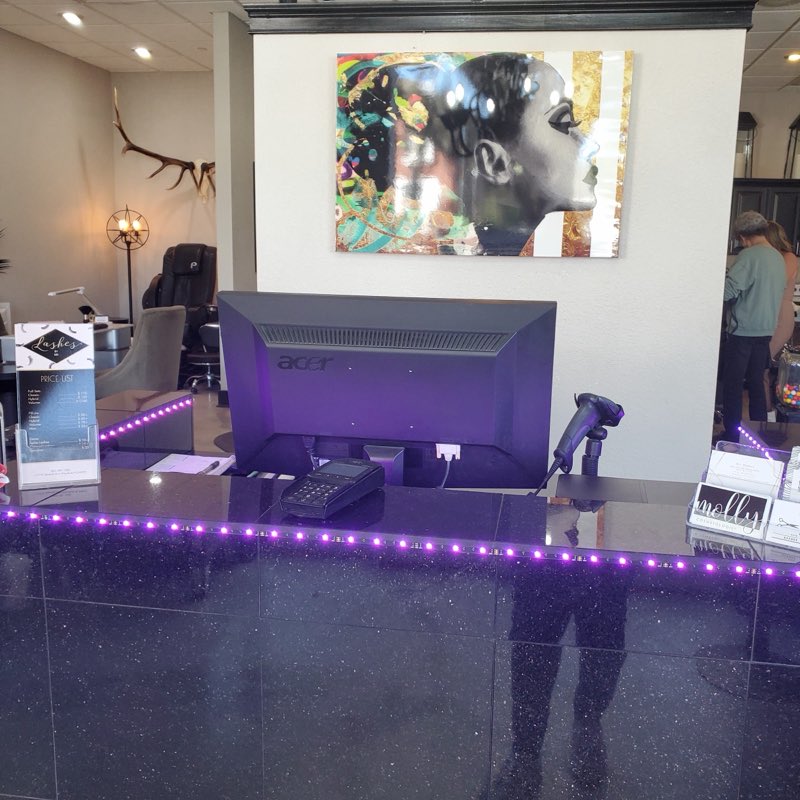 Reception desk with accent lighting and wall art